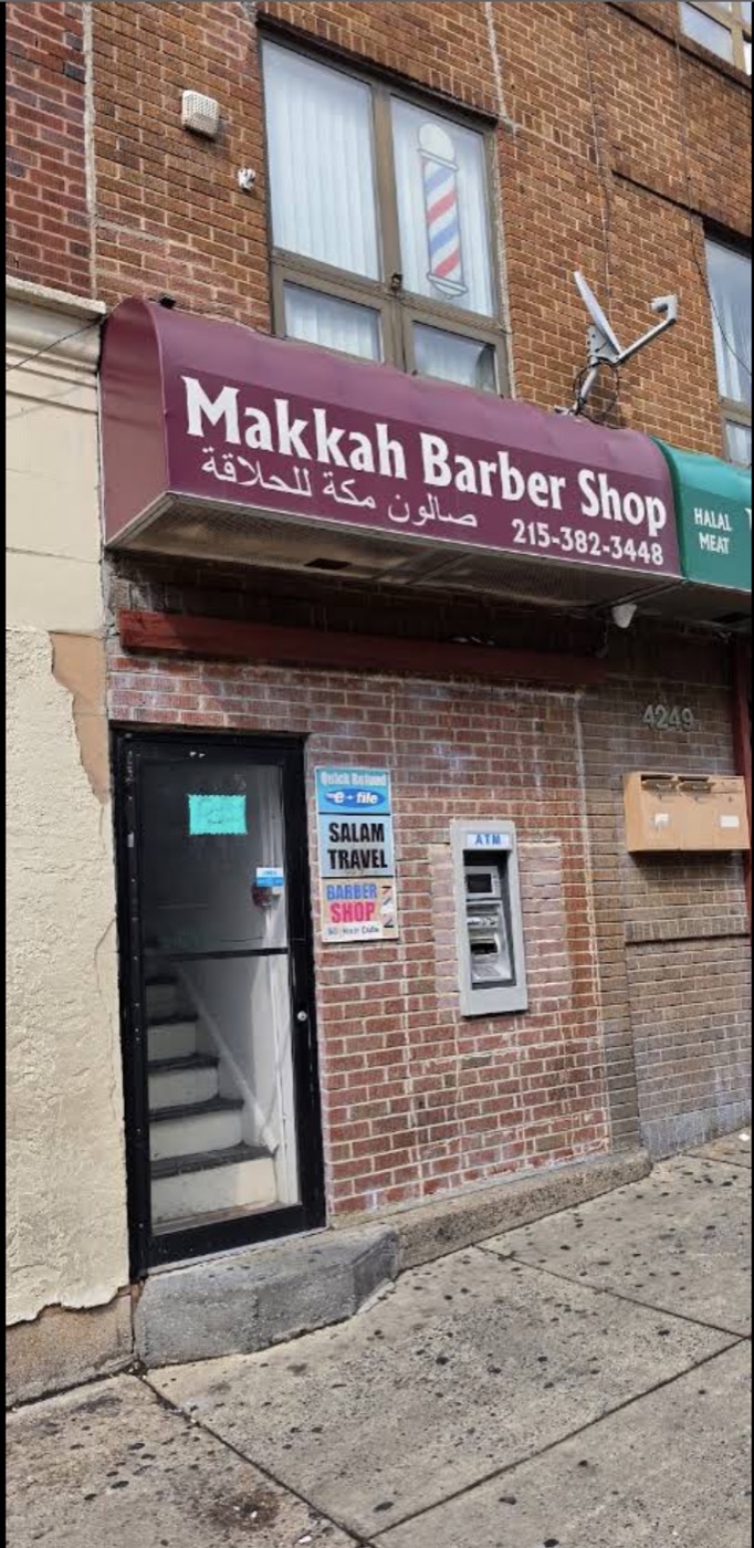 Makkah Barber Shop storefront on Walnut Street, with the barber pole in the upstairs window